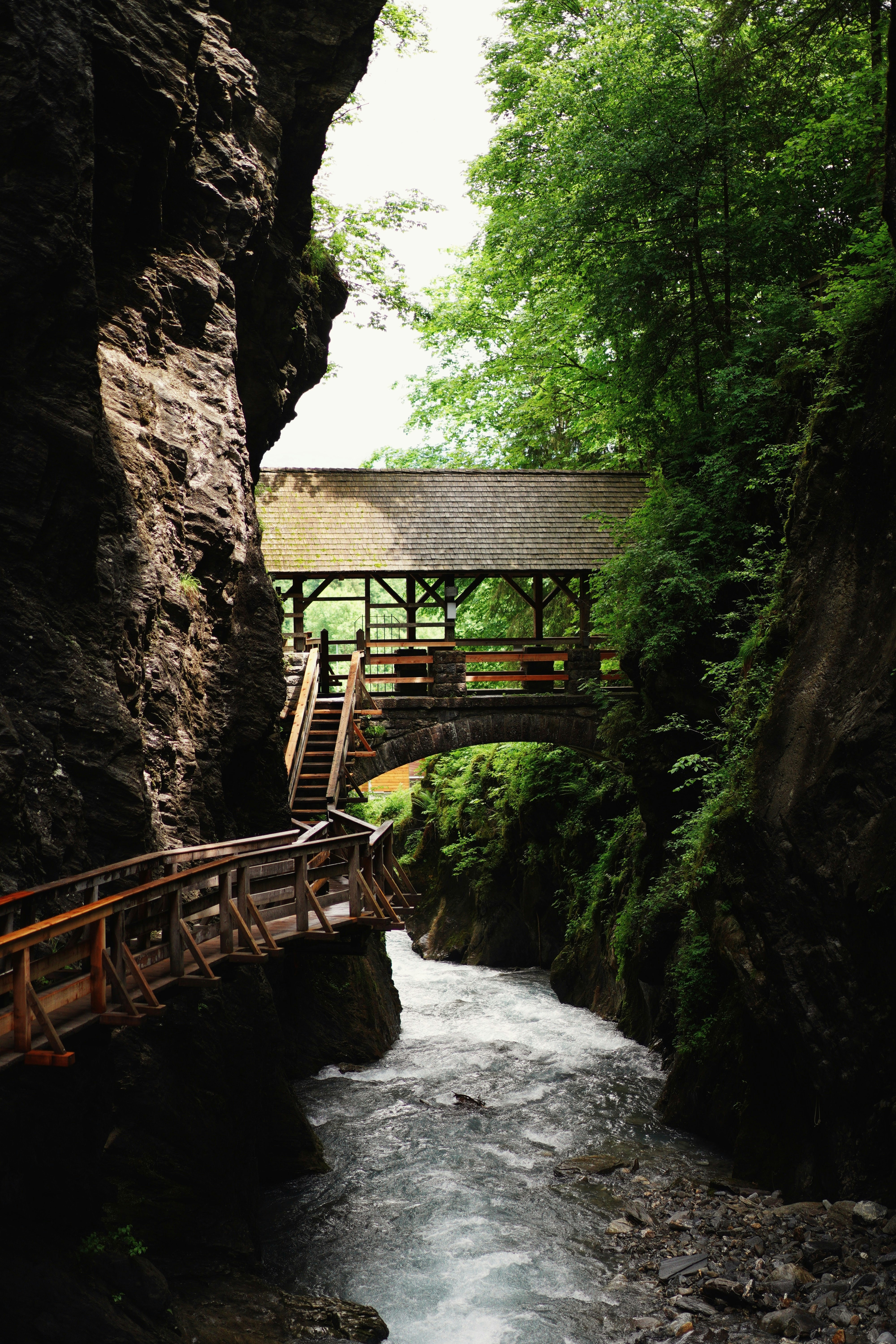 brown wooden bridge over river